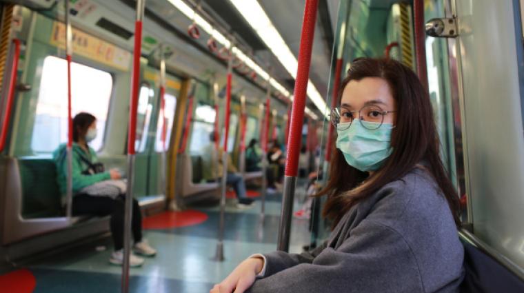 Asian girl in metro wearing face mask