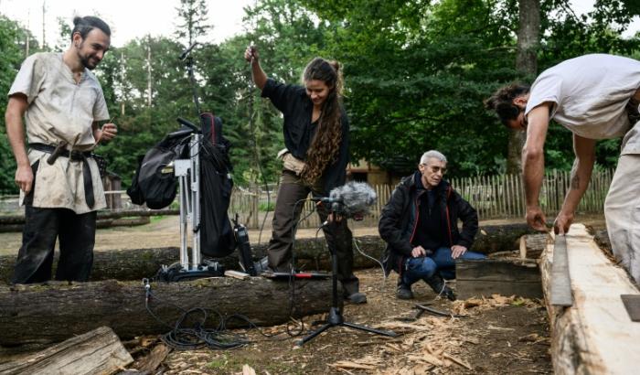 Mylène Pardoën (2e g), chercheuse au CNRS et archéologue du patrimoine sonore, enregistre les sons du travail manuel des bâtisseurs du château de Guédelon, qui utilisent des techniques et des outils du XIIIe siècle pour construire un château fortifié à Trège, le 11 septembre 2025 dans l'Yonne