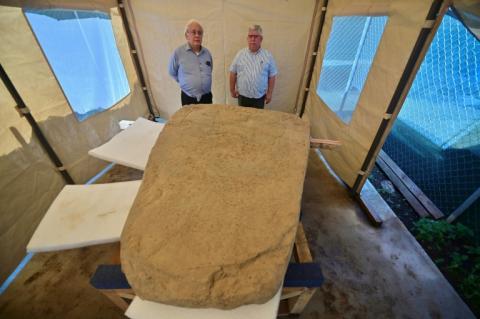 Les archéologues Lino Espinoza (g) et Alberto Vazquez (d) près d'une stèle de 2,5 tonnes découverte sur un site archéologique à Coatepec, au Mexique, le 18 juin 2026
